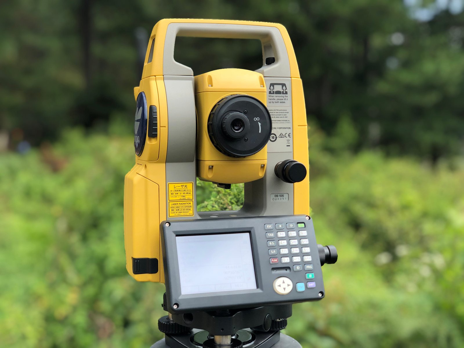 Total station closeup in forest — boundary survey